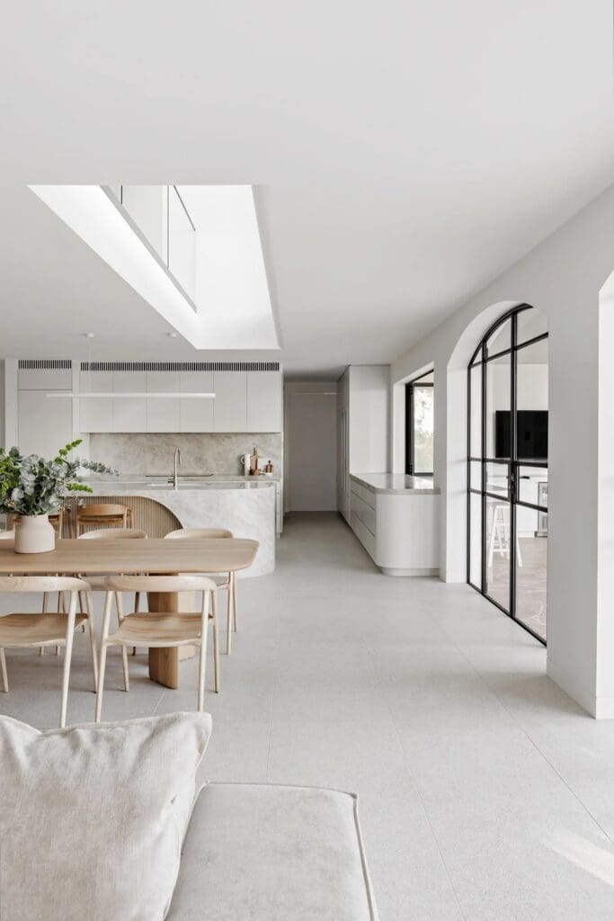 Living and dining to kitchen with extra large skylight at The Stables Burraneer House