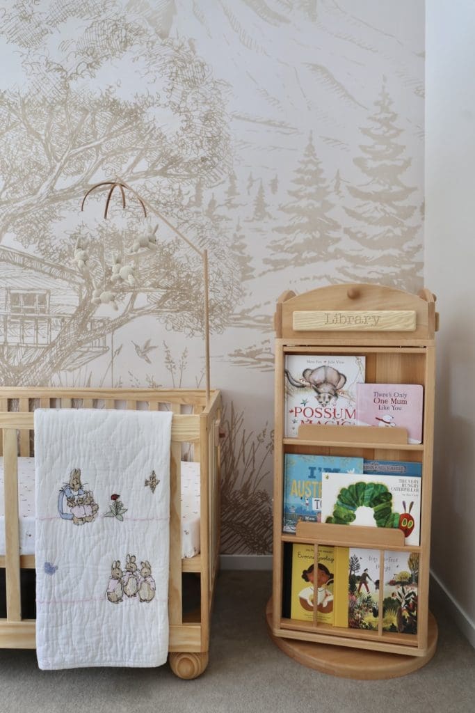 Woodland wallpaper and timber book case in nursery