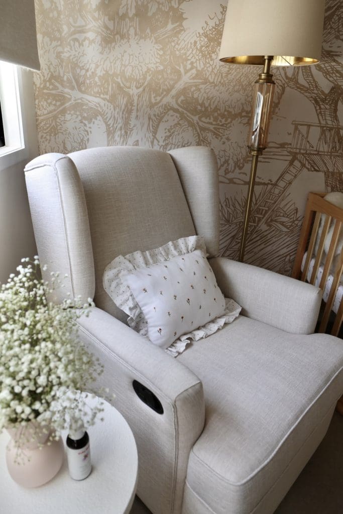 Grey nursing chair with frilled cushion in nursery