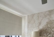 White side table and feeding chair in nursery