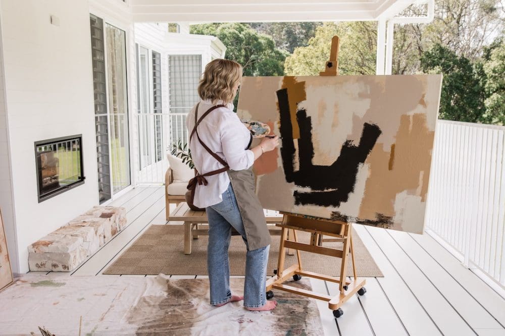 Bec Talbot painting abstract canvas on outdoor deck