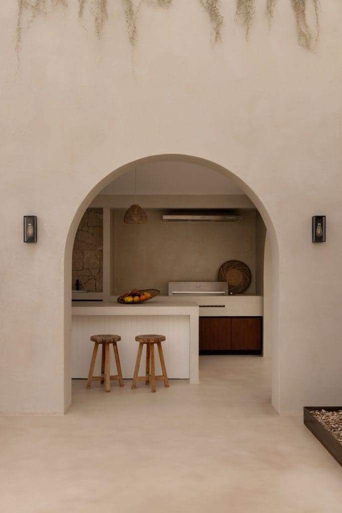 Arch to outdoor kitchen at Coastal Alchemy by The Stylesmiths