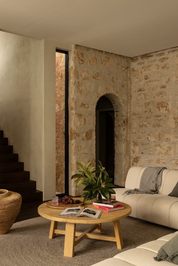 Limestone wall in living room of Coastal Alchemy by The Stylesmiths