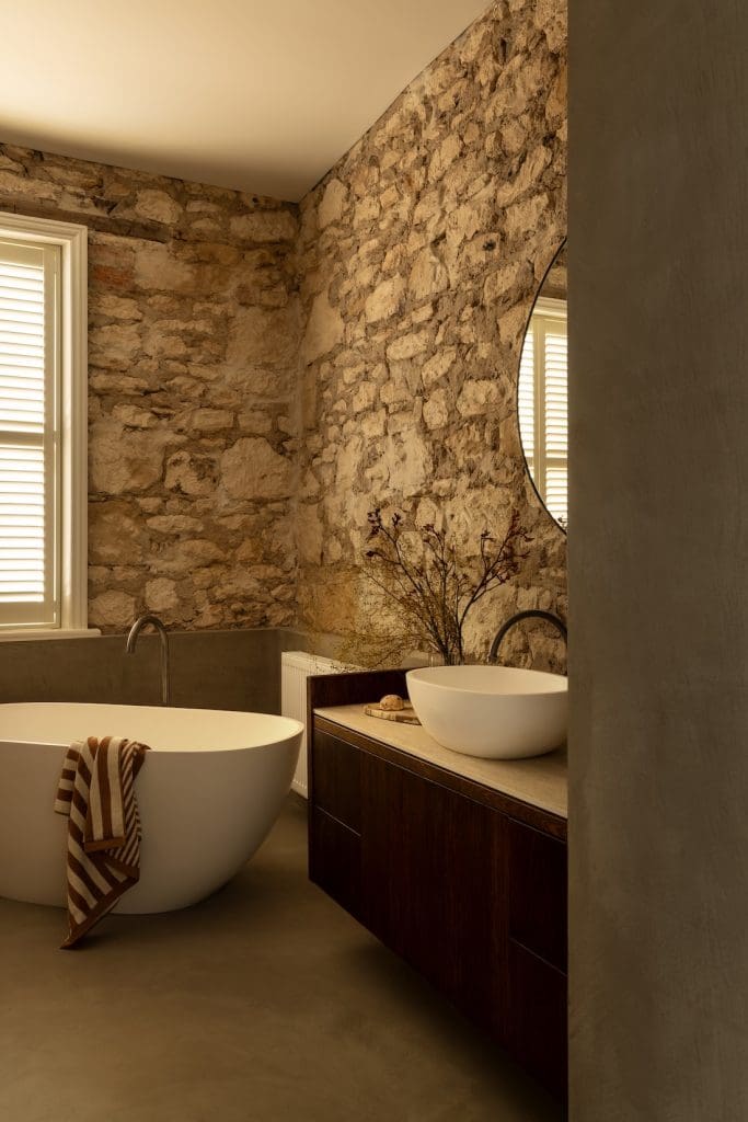 Limestone bathroom in Coastal Alchemy by The Stylesmiths