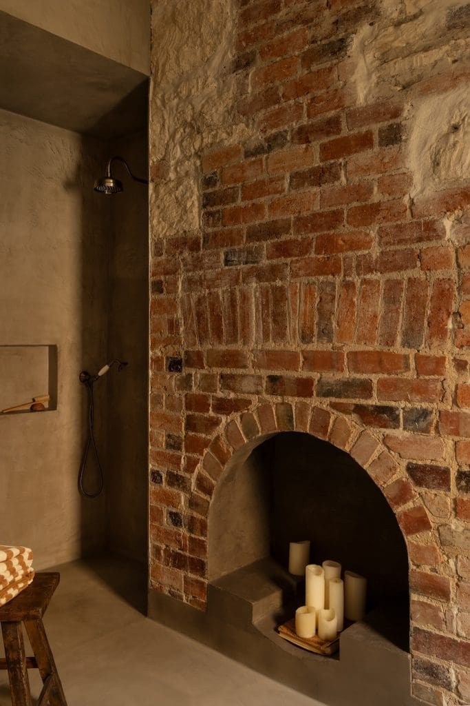 Stone fireplace at Coastal Alchemy by The Stylesmiths