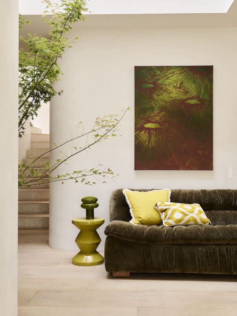 Warm natural living room with velvet green sofa