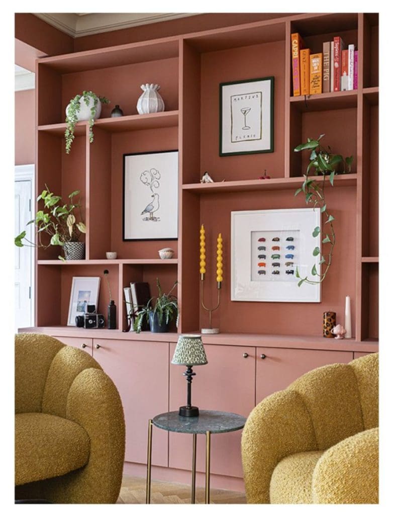 Bookshelves painted in a terracotta or dusty rose hue
