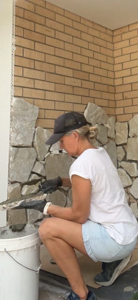 DIY stone wall makeover by Bec Riley from Rileygoodadventures - applying the adhesive to the stone