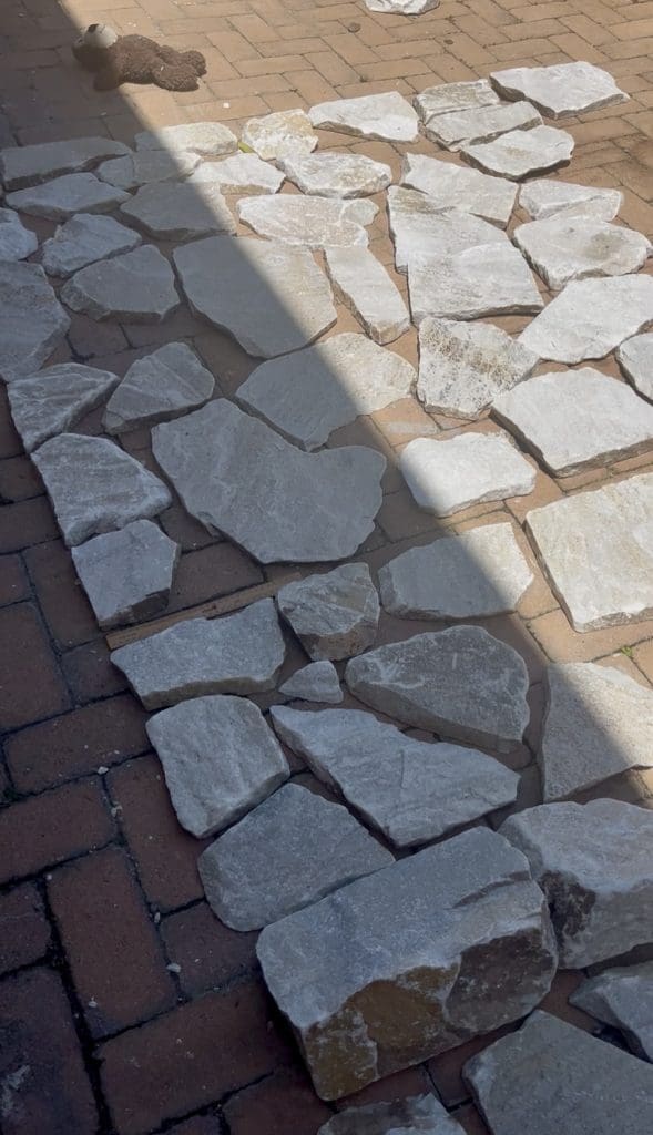 DIY stone wall makeover by Bec Riley from Rileygoodadventures - laying out the stone