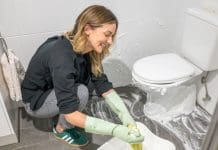 Wiping up shaving cream using a clean towel