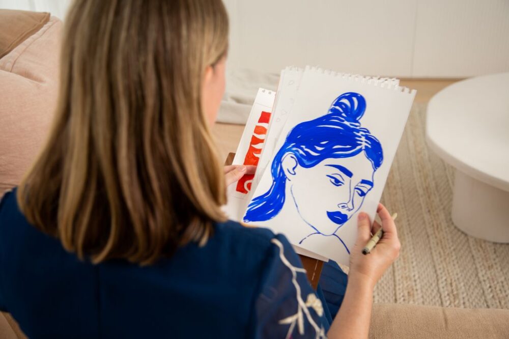 Artist sketching a woman with blue ink