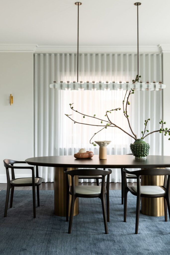 Round dining table with sculptural pendant light