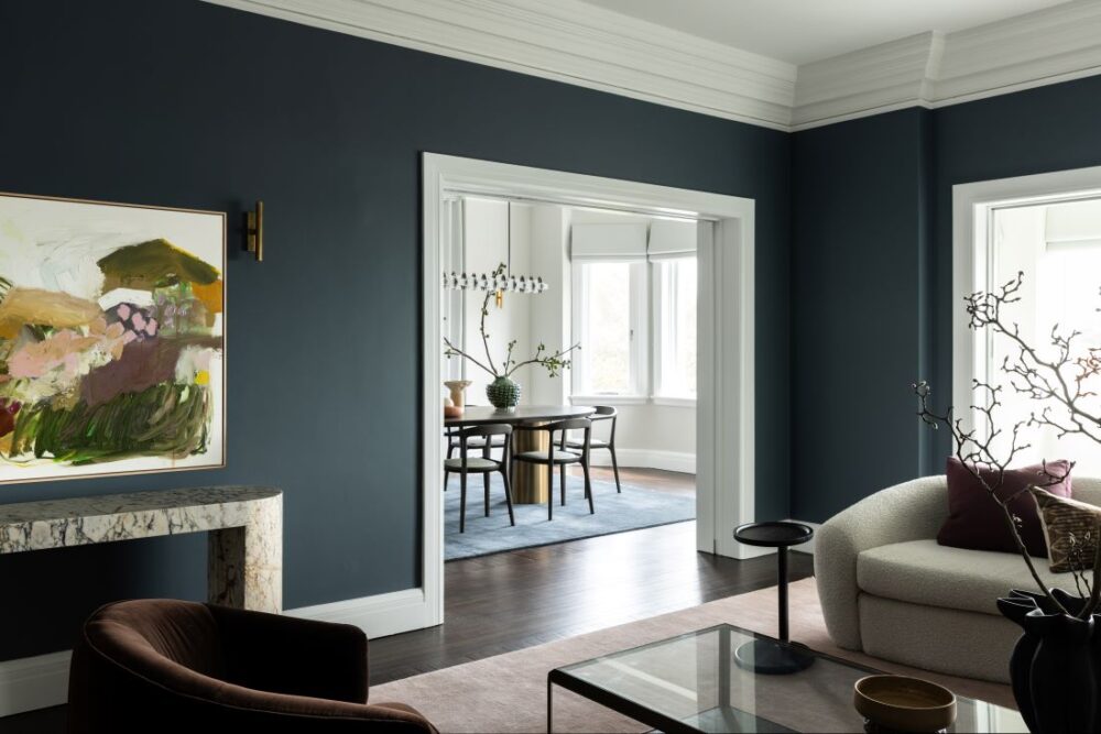 Living room with blue walls and view to dining room
