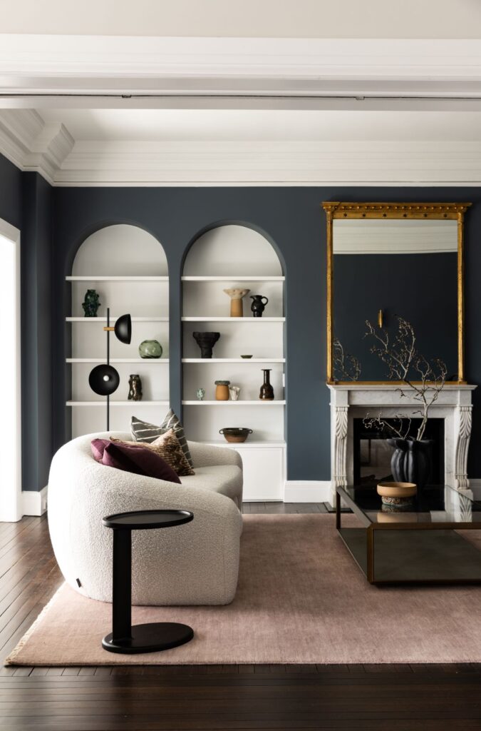 Curved sofa and arched shelves in living room