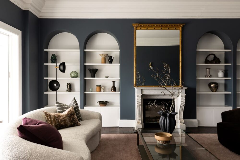 Living room with arched shelves and fireplace