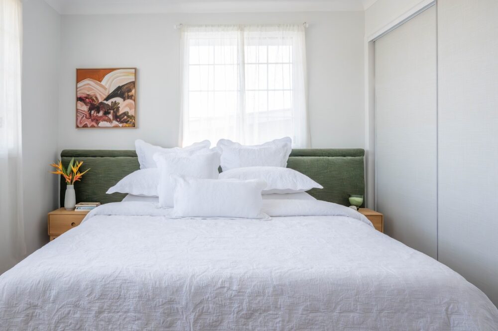 Layering pillows in solid colour bedding