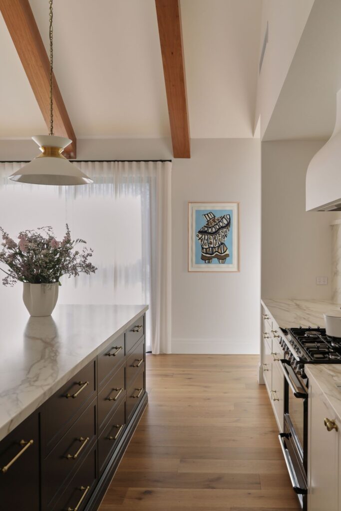 Modern farmhouse kitchen with marble benchtop and timber ceiling beams