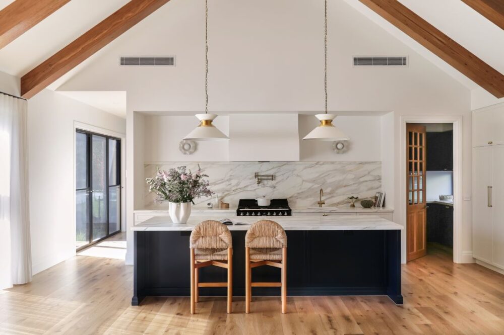 Modern farmhouse kitchen with timber beams and marble splashback