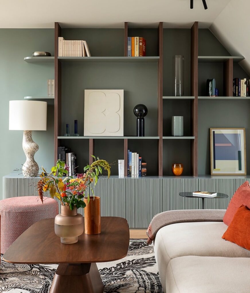 Green painted bookcase in living room