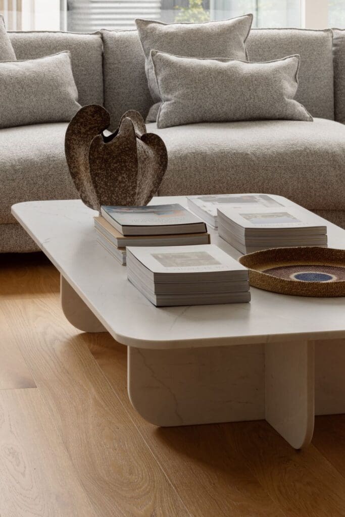 Modern, minimalist coffee table featuring books and home decor