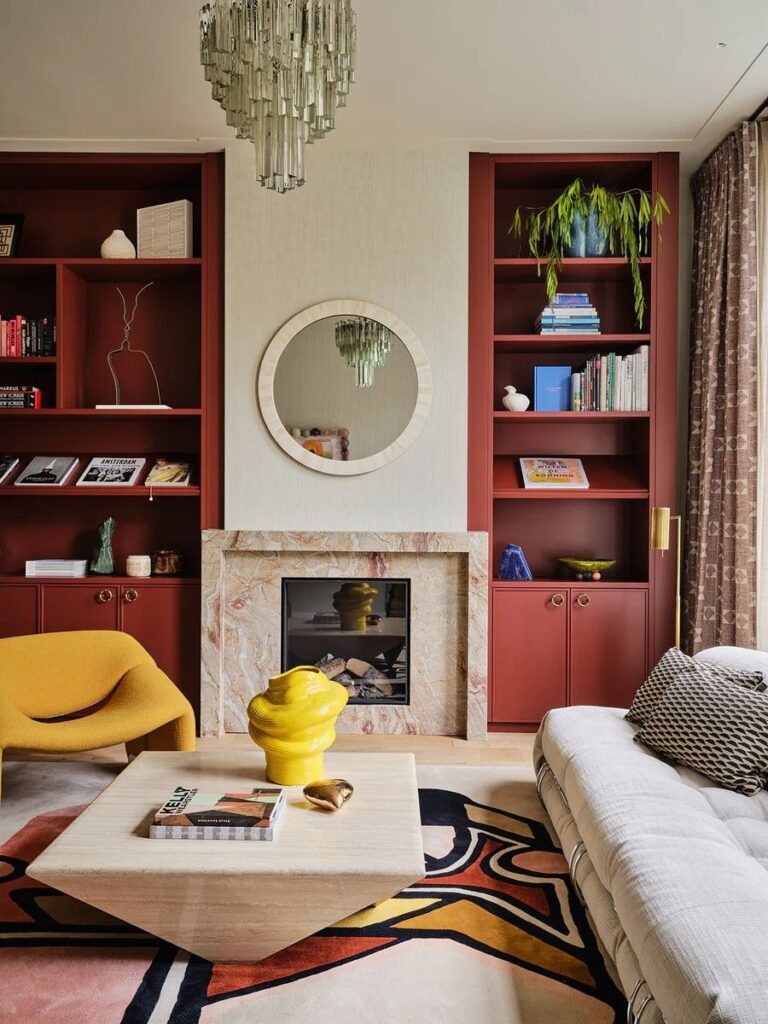 Dual burgundy bookcases aside fireplace