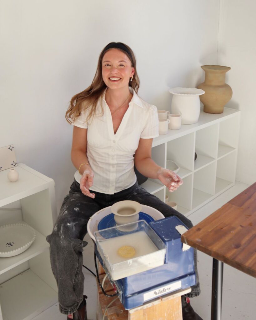 Eva Temple shaping ceramics in studio