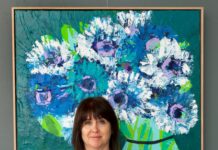 Lost in colour: The nostalgic artworks of Anna Blatman Artist portrait beside large floral artwork
