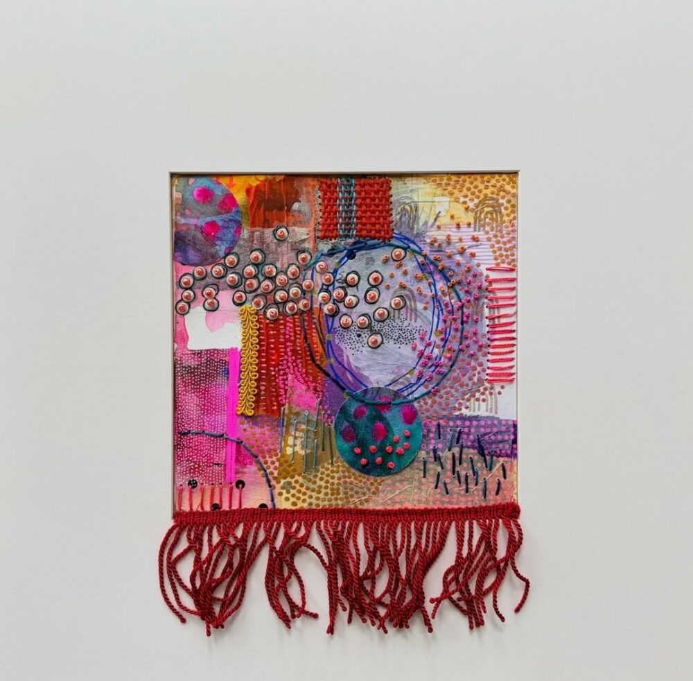 Red fringed embroidered artwork by Elizabeth Sullivan