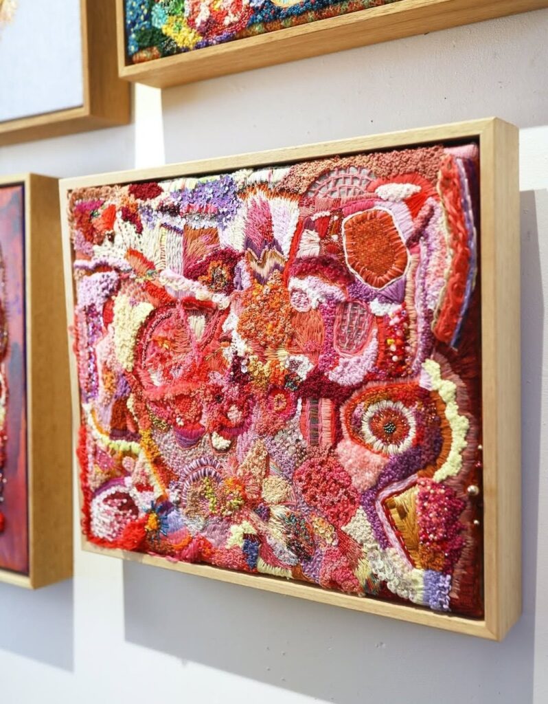 Red and pink embroidered artwork by Elizabeth Sullivan