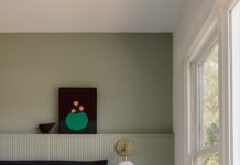 Design your bedroom for better sleep Bedroom with blue throw and green fluted half-height wall