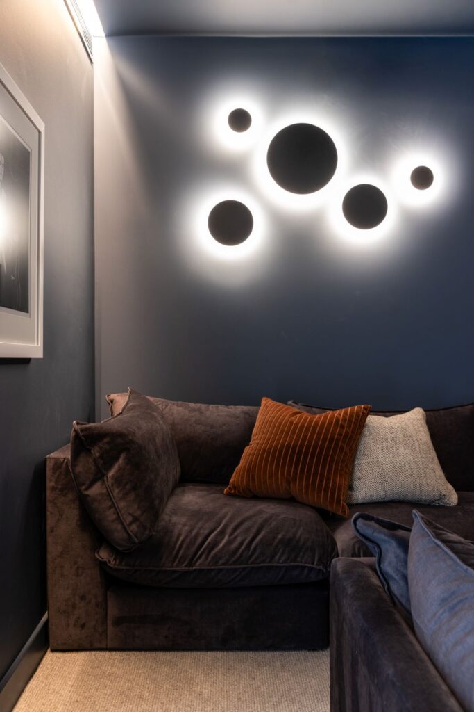 Cozy lounge area with plush seating and modern lighting by Annie Bowen at North Avoca Beach House.