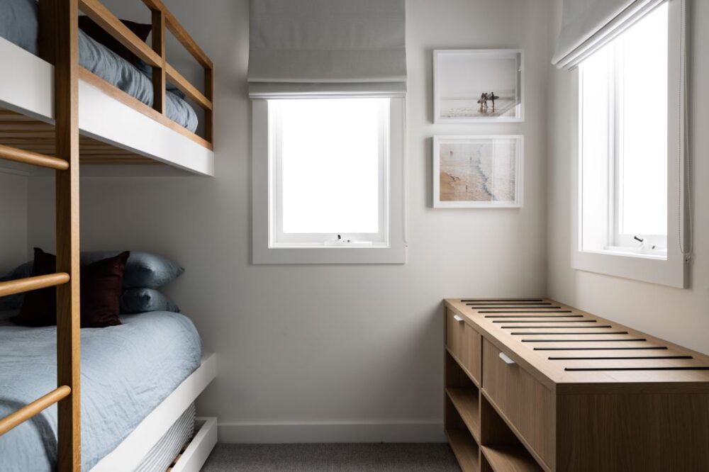 Cozy bunk room with modern design, artwork, and natural light by Annie Bowen at North Avoca Beach House.