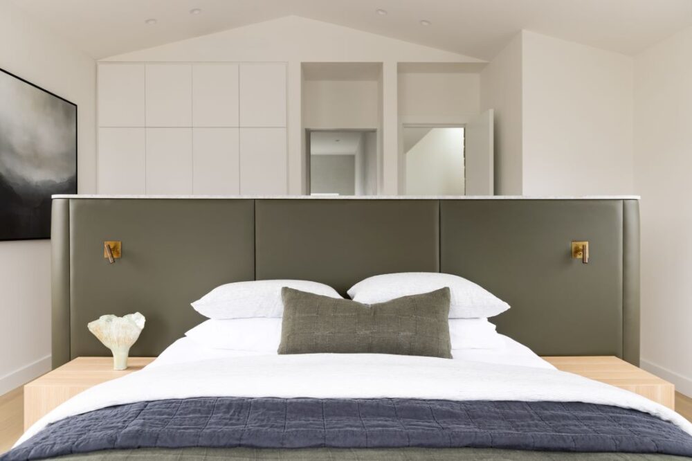Contemporary bedroom with stylish headboard and minimal décor by Annie Bowen at North Avoca Beach House.