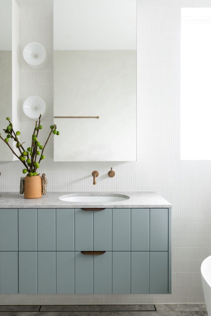 Stylish bathroom vanity with stone countertop, minimalist design, and modern fixtures by Annie Bowen at North Avoca Beach House.