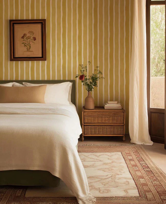 Master bedroom featuring striped wallpaper