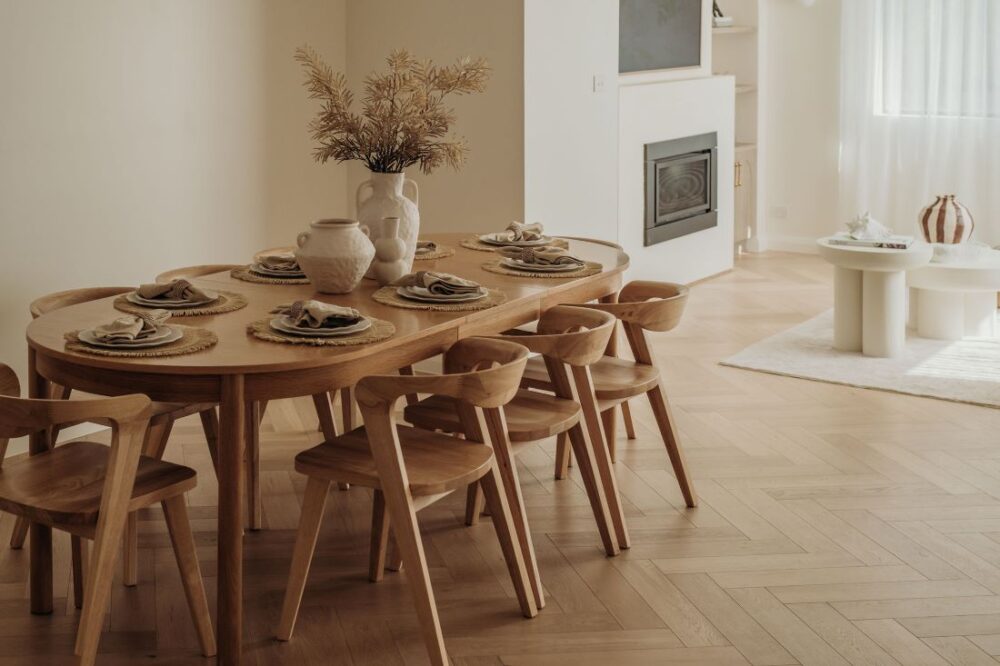 Elegant dining area with wooden table and contemporary design by Sabina Christine Interiors at 48 Bilwara Avenue
