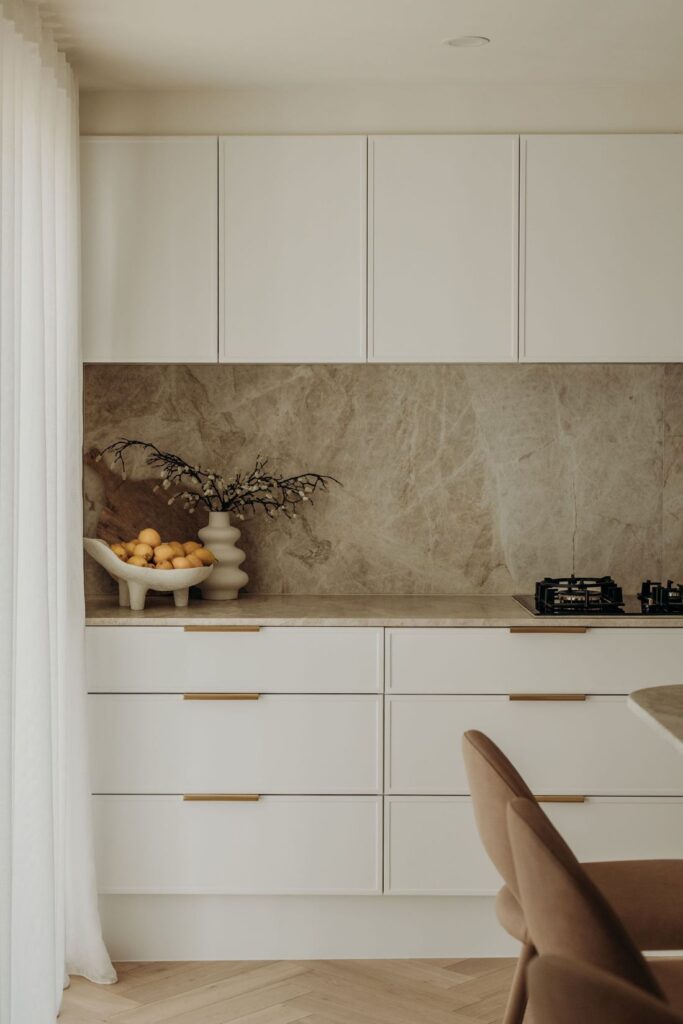 Modern kitchen corner with marble backsplash, elegant storage, and fresh décor by Sabina Christine Interiors at 48 Bilwara Avenue.