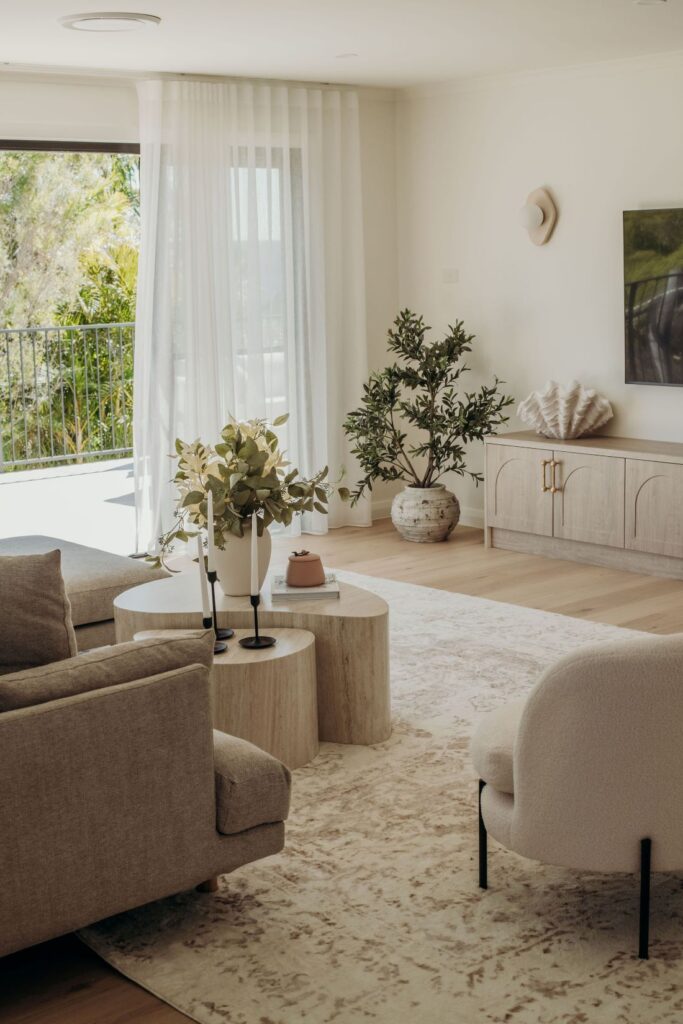 Light-filled living room with neutral décor and modern furnishings by Sabina Christine Interiors at 48 Bilwara Avenue.