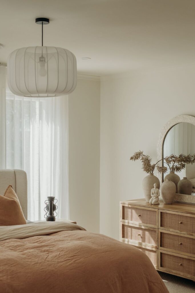 Cozy bedroom with modern lighting, neutral tones, and elegant décor by Sabina Christine Interiors at 48 Bilwara Avenue.