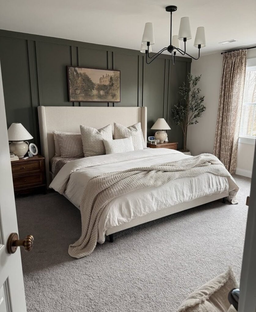 Green panelled feature wall with black chandelier in bedroom
