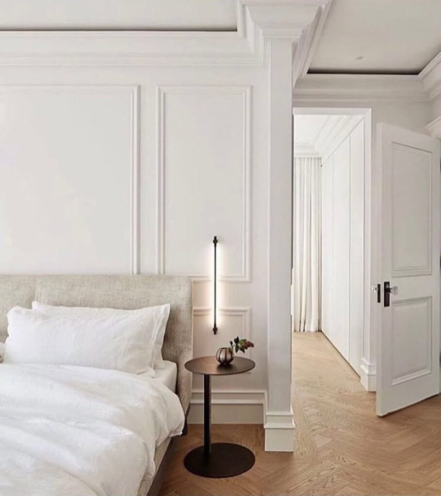 White bedroom with panelling and crown moulding