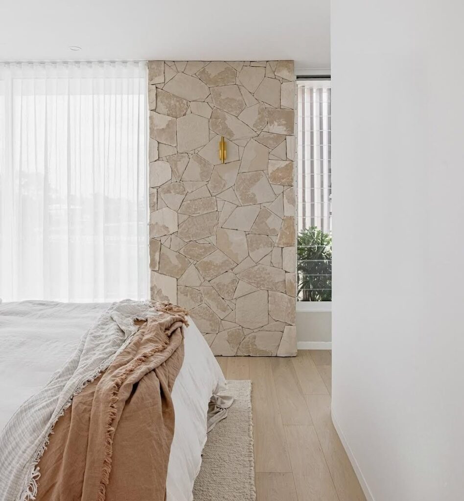 Stone wall feature in bedroom