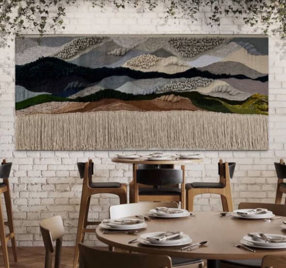 Large woven textile artwork above dining tables in modern restaurant