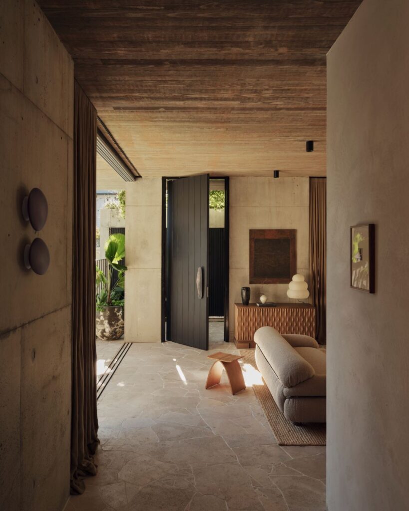 View into modern lounge with stone flooring and textured sofa