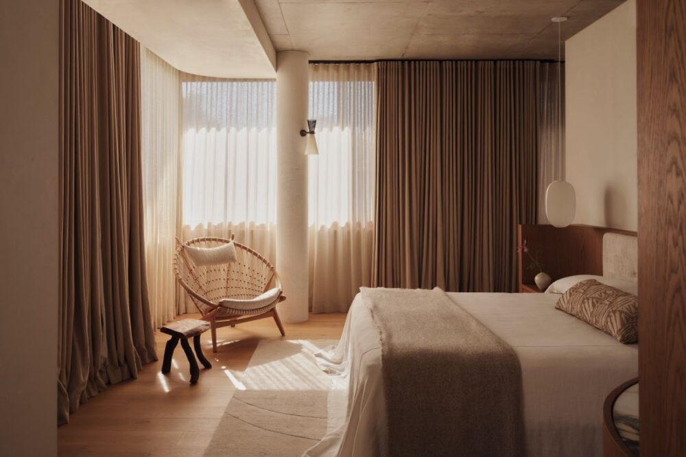Bedroom with beige linens and natural wood textures
