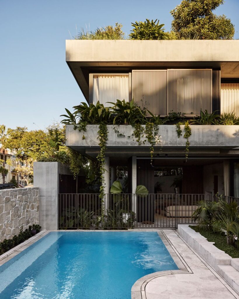Concrete residence with rooftop greenery and pool