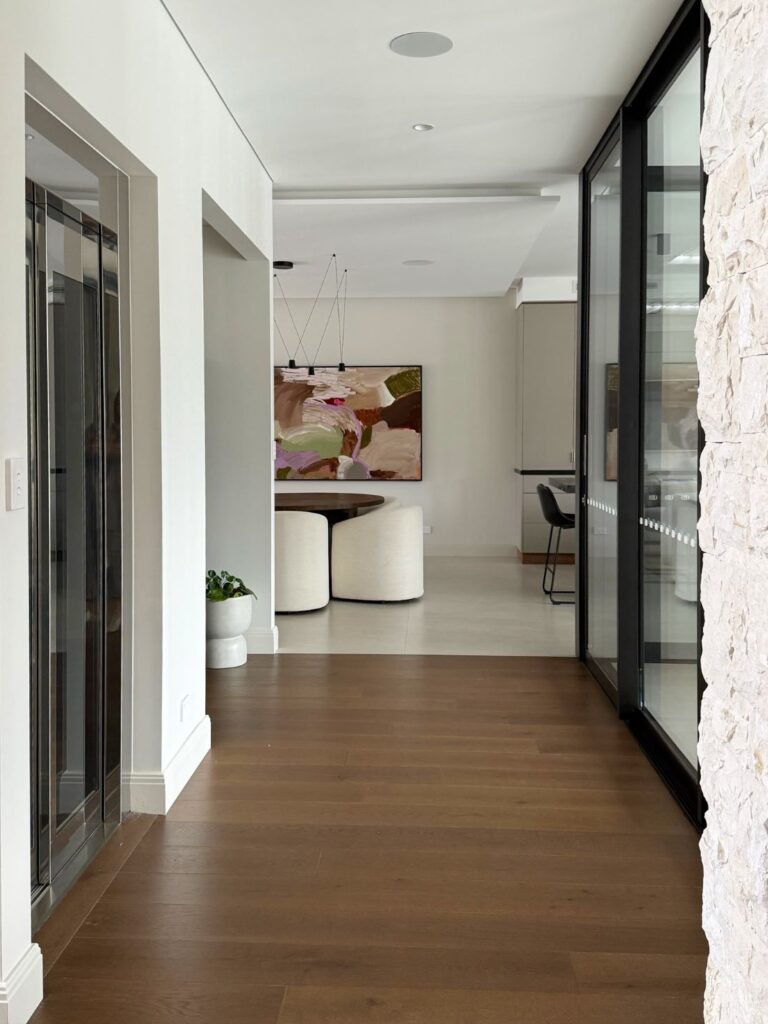 Abstract painting in dining area with pink and earthy tones