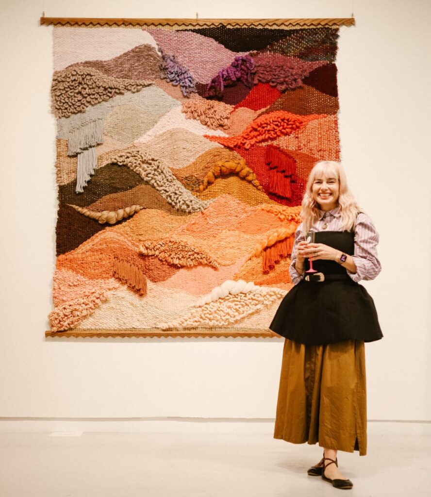 Large multicoloured woven wall hanging with textured fibre landscape
