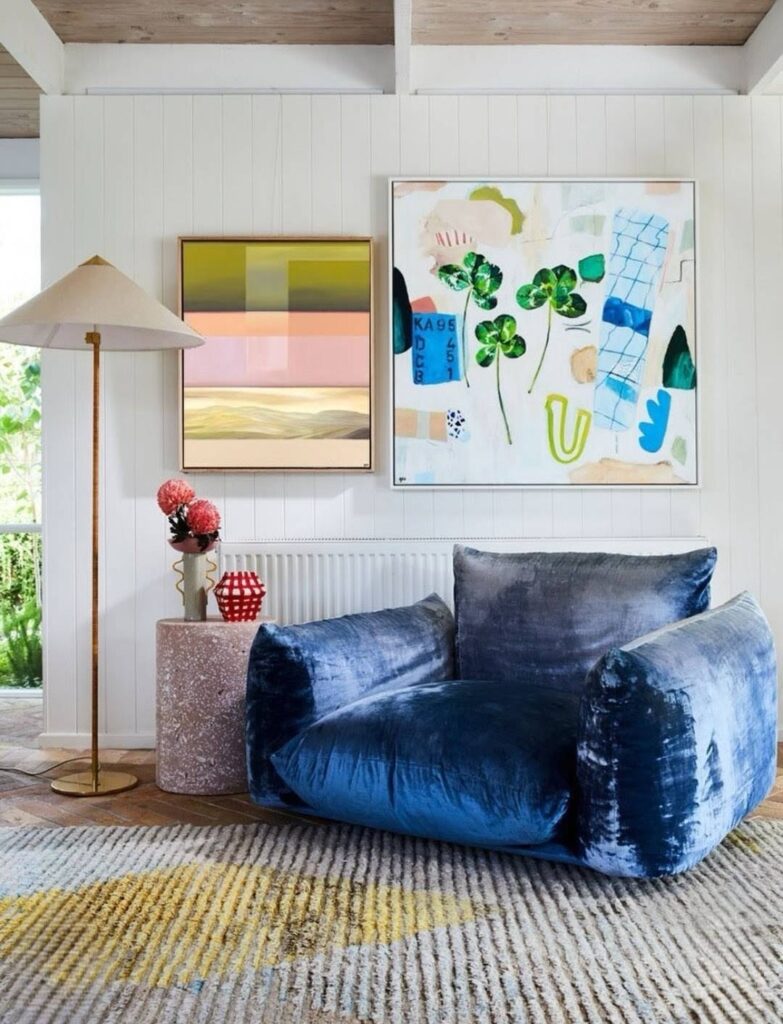 Blue velvet chair with 2 paintings from Georgie Wilson