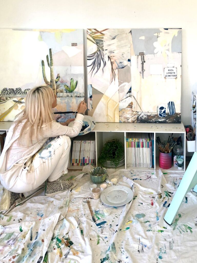 Artist painting abstract tropical-inspired artworks on large canvases in a studio